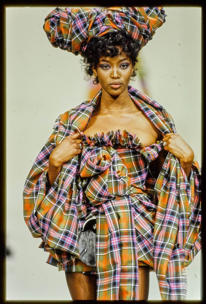 Model, Naomi Campbell wearing a Vivienne Westwood plaid dress and headpiece