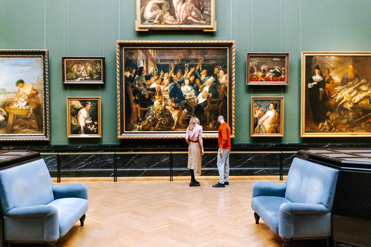 A photograph of two people looking at art in the Kunsthistorisches Museum