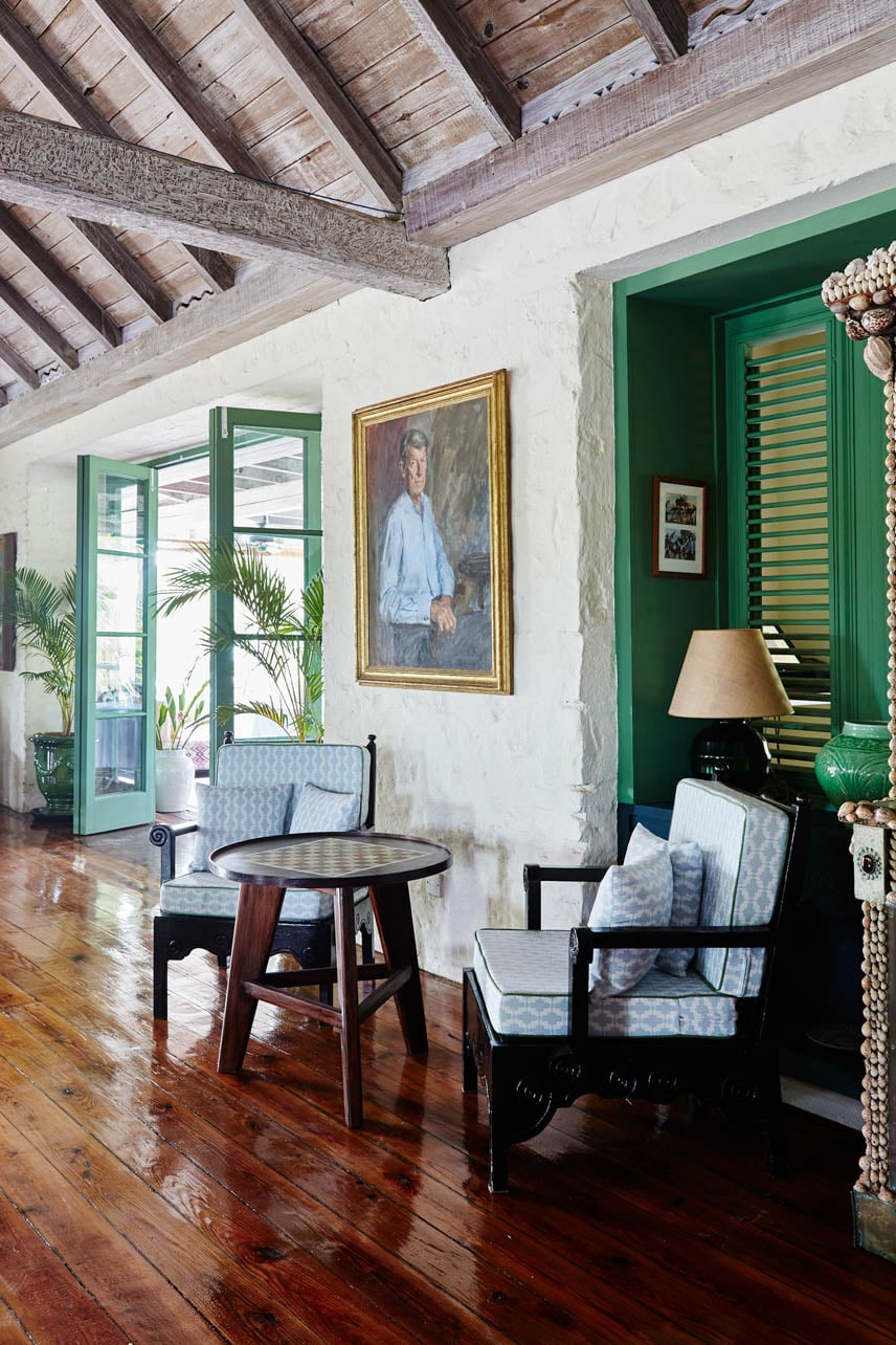 A painting and a green door in the Great Room at Cotton House in Mustique