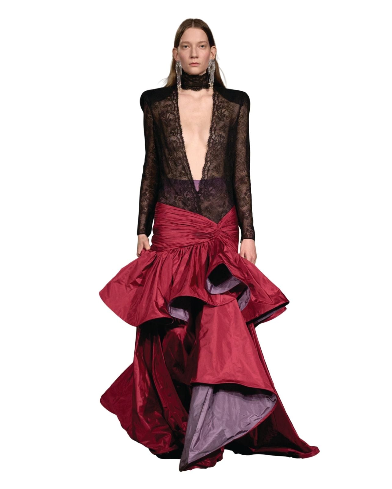 A runway shot of a black lace and red dress from Valentino