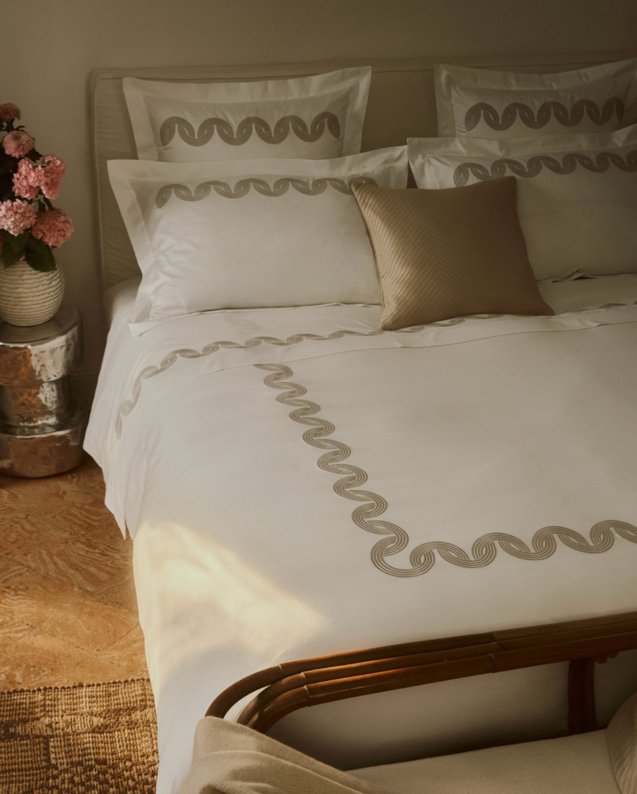Bed with Frette white linen with gold printed stitching